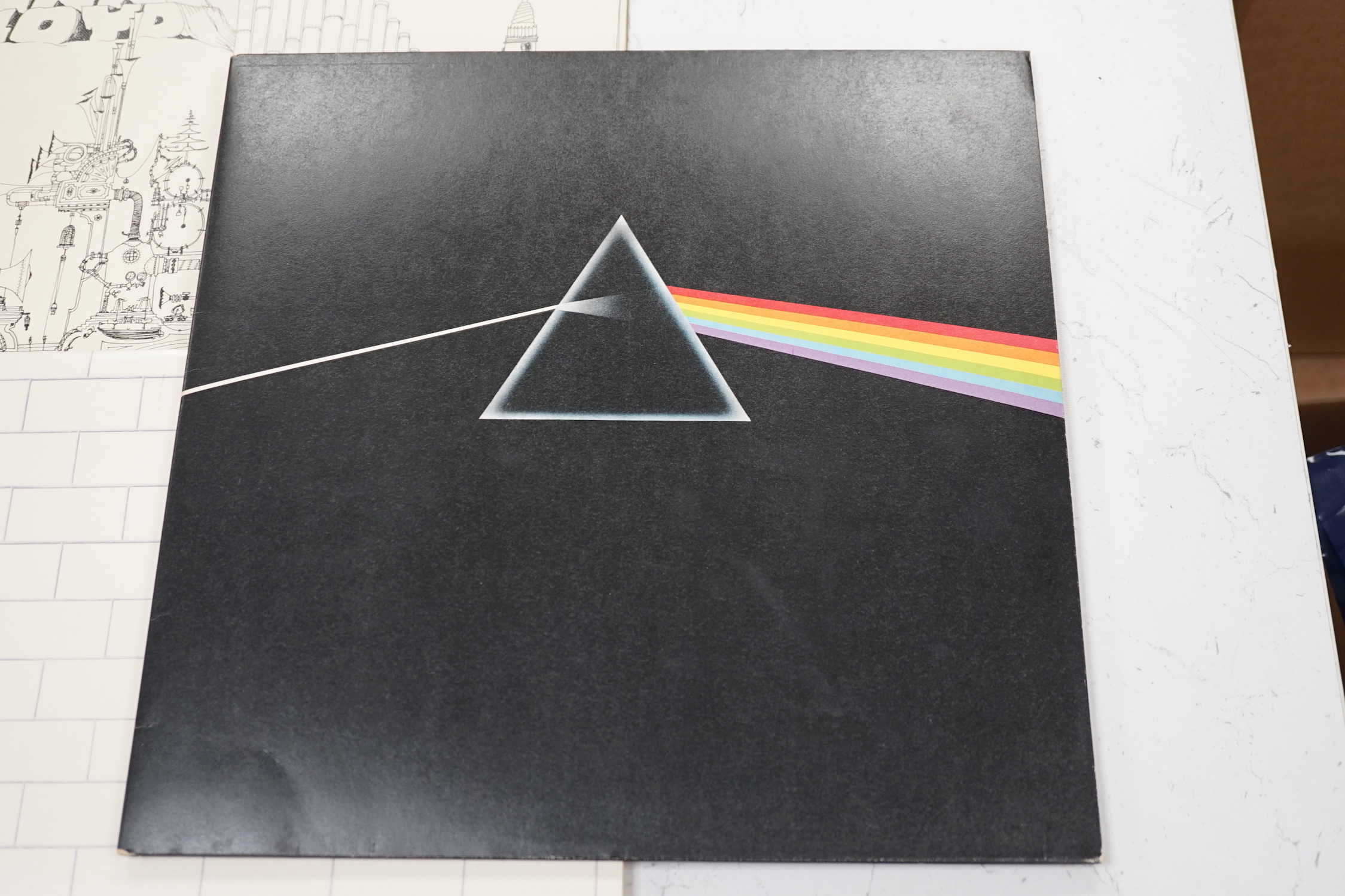 Three Pink Floyd LP record albums; Dark Side of the Moon, on Harvest SHVL 804, with both posters and black inner sleeve, The Wall, on Harvest SHSP 4111 A 2U, Relics, on Starline, SRS 5071